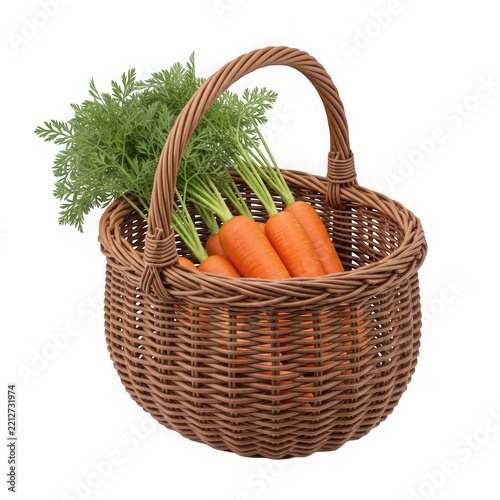 Brown basket filled with fresh carrots and greens