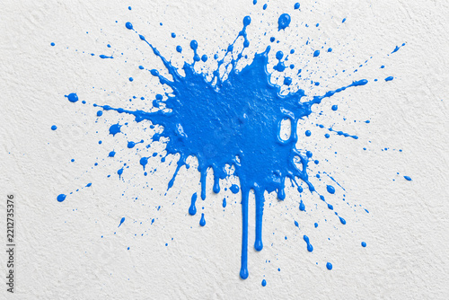 Blue paint splatter on a wall