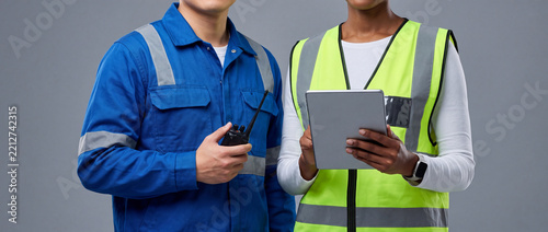 Professional Industrial Engineers and Construction Workers Using Tablet and Radio for Site Management