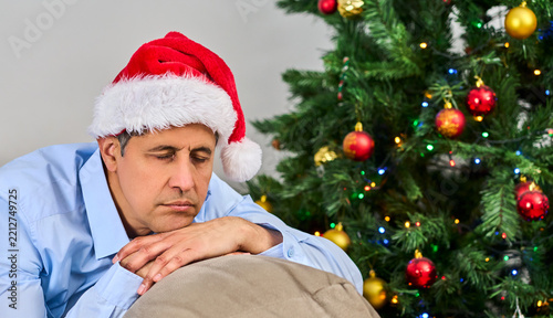 Close up of a man asleep and sick on the couch at home Christmas at home