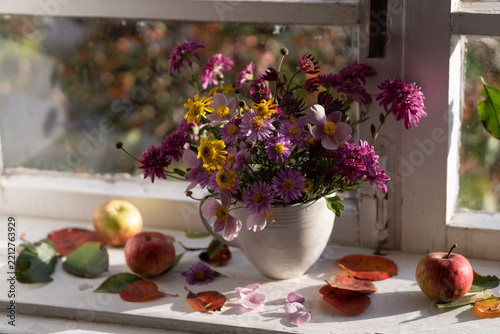 A bouquet of autumn asters on the windowsill