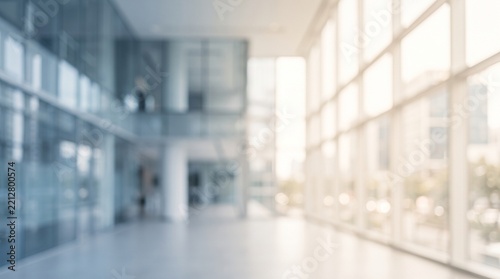 Blurred Modern Office Lobby with Glass Walls and Natural Sunlight for Professional Backgrounds