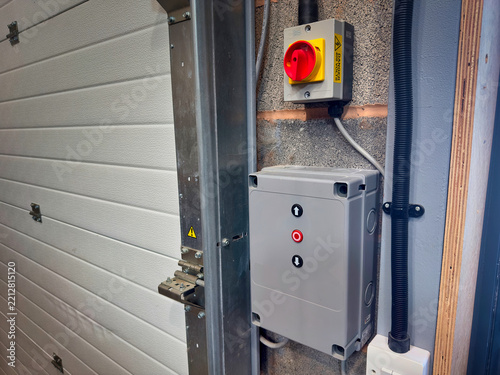 Industrial Roller Shutter Door Control Box and Rotary Isolator Switch on Concrete Block Wall
