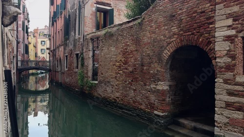 Solitary Walker Crossing Stone Bridge Over Venice Canal