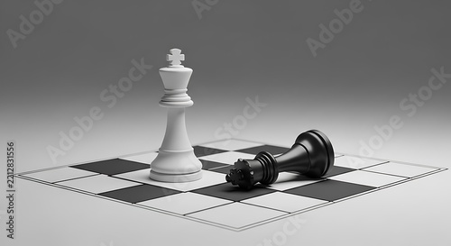 White chess king standing over fallen black king on board