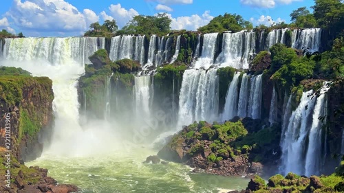 Iguazu Falls, Argentina, majestic waterfall cascading over lush green cliffs with mist and roaring water, scenic natural wonder and travel destination, video footage