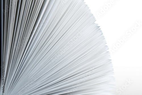 Stack of white papers, pages fanned out.