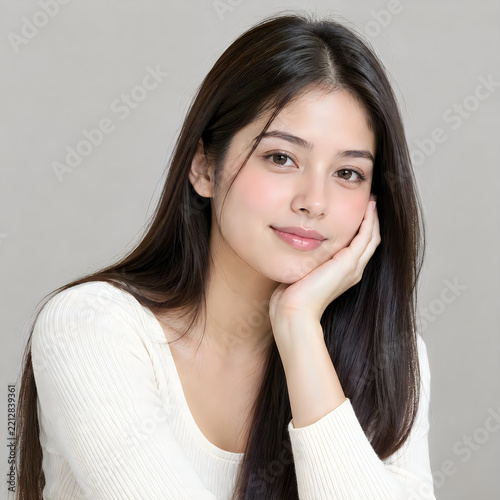 Smiling woman with long dark hair posing cheerfully