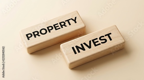 Two wooden blocks with property and invest written on them representing real estate investment concept
