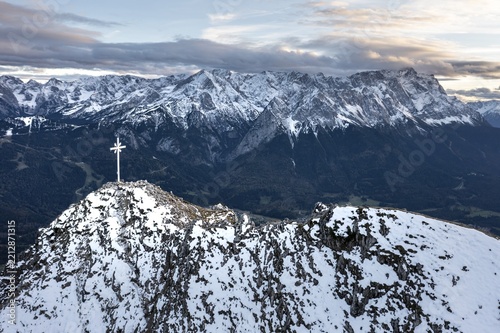 Alpine panorama with Zugspitze and summit cross of the Kramer, aerial view, mountains with snow in the evening, summit of the Kramer, Garmisch, Bavaria, Germany