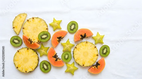 Vibrant assortment of tropical fruit slices on linen tablecloth