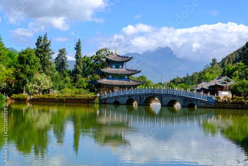 Dehe Pavilion (Deyue Tower) and the stone Five-Hole Bridge reflected in Black Dragon Pool, Heilongtan Park in front of Elephant Mountain, Lijiang, Yunnan Province, China