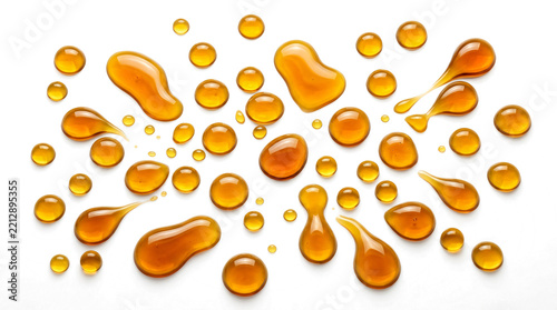 Honey drops splatter and flowing golden syrup liquid splashes isolated on transparent background