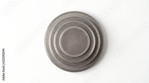 Top down view of a stainless steel blind filter basket blanking disc used for backflushing and cleaning commercial espresso machine group heads perfectly isolated on a solid white background.