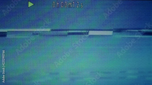 Broken VHS playback glitch with blue noise and timecode overlay