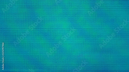 Macro teal and blue glitch noise on LCD pixel screen texture