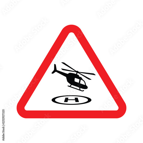Red and white triangular safety warning sign graphic featuring a black silhouette of a helicopter hovering above a helipad with an H letter symbol indicating aviation hazard