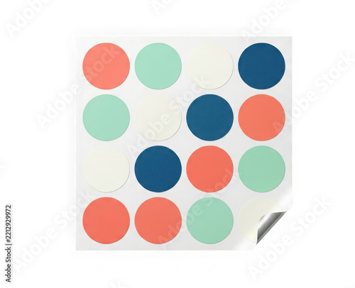 Sheet of colorful round adhesive stickers in coral, mint, cream, and dark blue, organized in a grid pattern isolated on transparent background