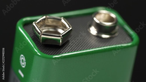 Green nine volt battery designed to provide reliable electrical power for various electronic devices and household equipment