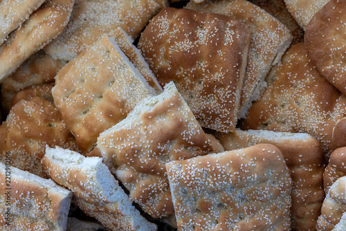 Traditional Greek Lagana Bread Topped with Sesame Seeds at a Local Bakery