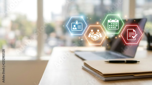 Laptop with digital business icons on a desk in a modern office