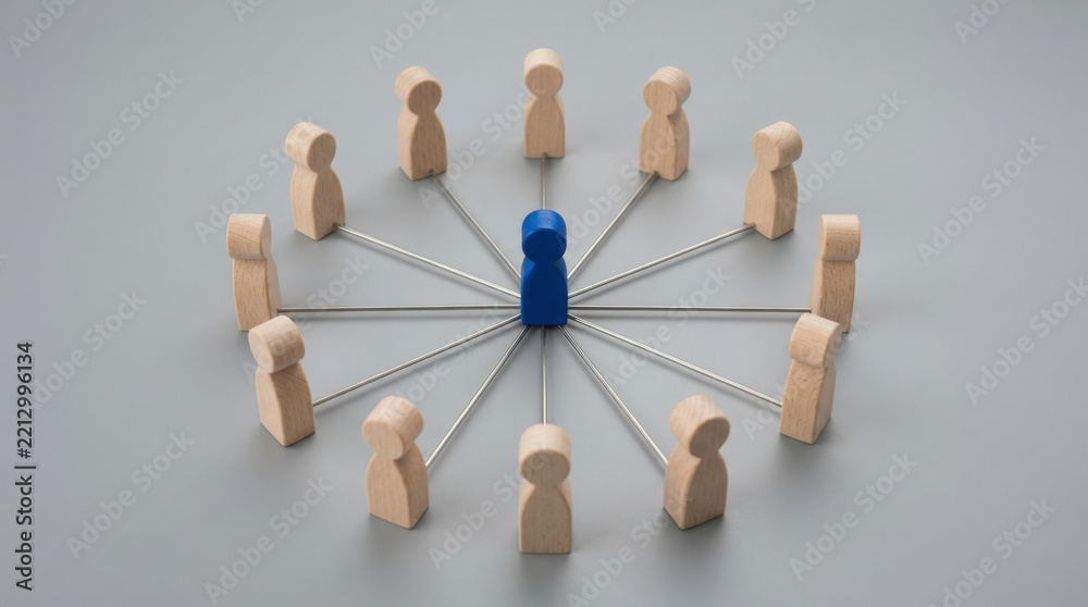 Obraz premium Centralized blue wooden pawn connected to surrounding neutral figures symbolizing leadership and organizational communication.