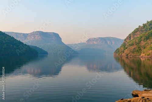 River valley with forested mountains and reflections
