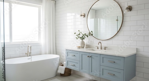 Bright modern bathroom with white subway tile and blue vanity