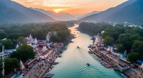 Aerial view of the Ganges river flowing through Rishikesh at sunset with temples
