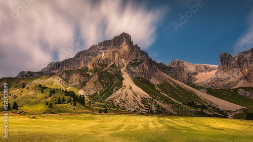 Scenic landscape of the Dolomites with dramatic rocky peaks and green valley in summer, Italy