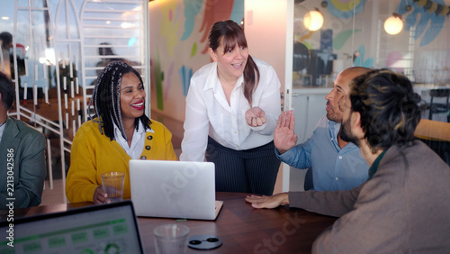 Professional businesswoman leading collaborative team meeting, diverse colleagues engaging in strategic brainstorming and sharing innovative ideas within modern office environment
