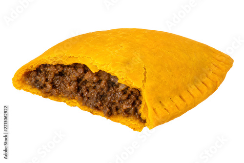 Jamaican beef patty with bright yellow-orange flaky half-moon shell Isolated on White Background