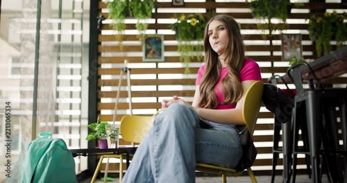 Teenage Girl Sitting in Cafe