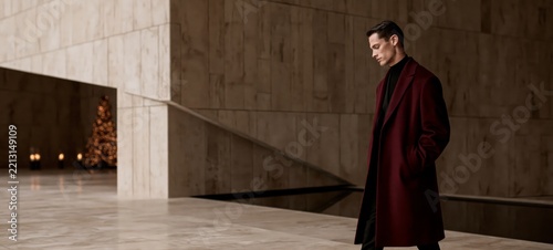 Luxury Christmas and New Year Fashion Campaign with Elegant Man in Burgundy Coat Walking Through Contemporary Hotel Lobby
