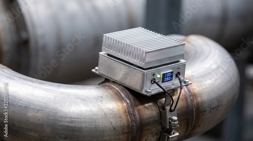 Thermoelectric module mounted on industrial exhaust pipe converting waste heat directly into electricity