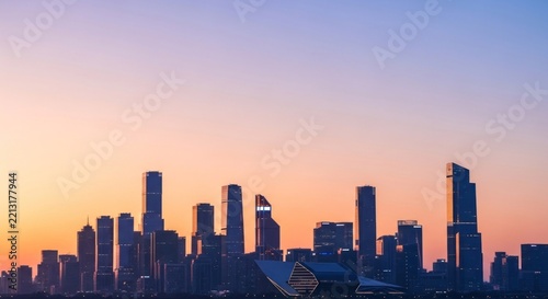 City skyline silhouetted against a colorful sunset sky background