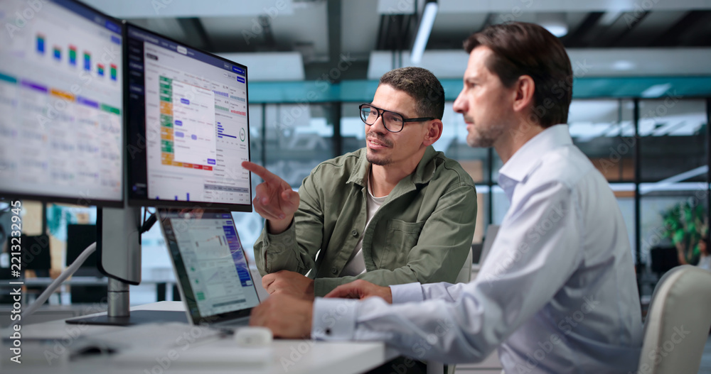 Fototapeta premium Insurance Underwriter Carefully Reviews Risk Data On Laptop