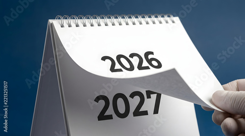 Calendar page turning from 2026 to 2027 showing upcoming year change concept.