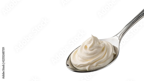 Metal spoon filled with thick creamy white yogurt or sauce isolated on transparent background