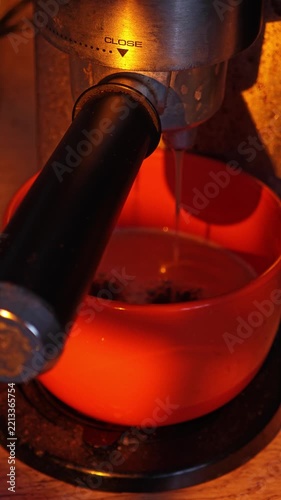 The coffee maker brews coffee and pours it into a mug.