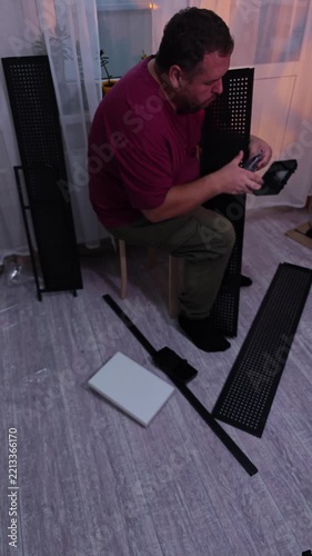 a man assembles a metal cabinet