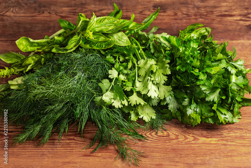 Heap of different leafy greens on an old rustic table