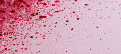 Pink and red powder splatter texture on a light pink background