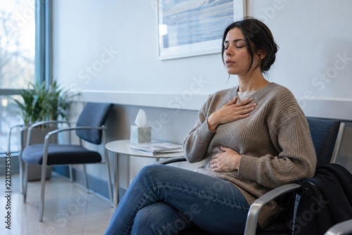 One anxious patient seated in a medical waiting room using measured breathing before an appointment, mental health and emotional wellbeing concept