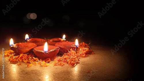 Canvas Print arranged clay diya oil lamp with marigold petals for diwali festival celebration