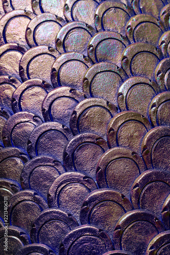 Textured purple and bronze iridescent serpent scale pattern on traditional Thai Naga sculpture