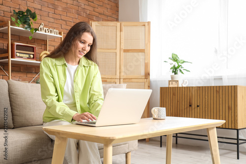 Remote work and digital nomad lifestyle, young woman working on a laptop from...