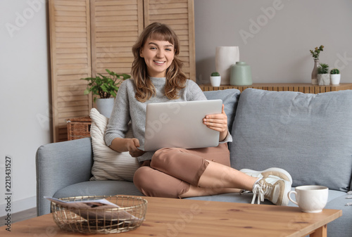 Remote work and digital nomad lifestyle, happy young woman using a laptop whi...