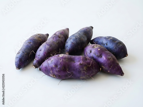 A group of fresh purple sweet potatoes isolated on white background