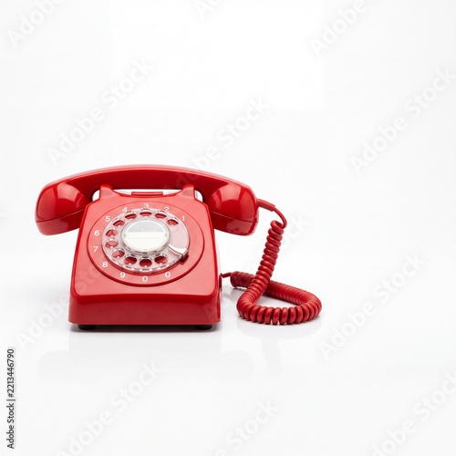 Bold Red Retro Rotary Dial Telephone on White Background